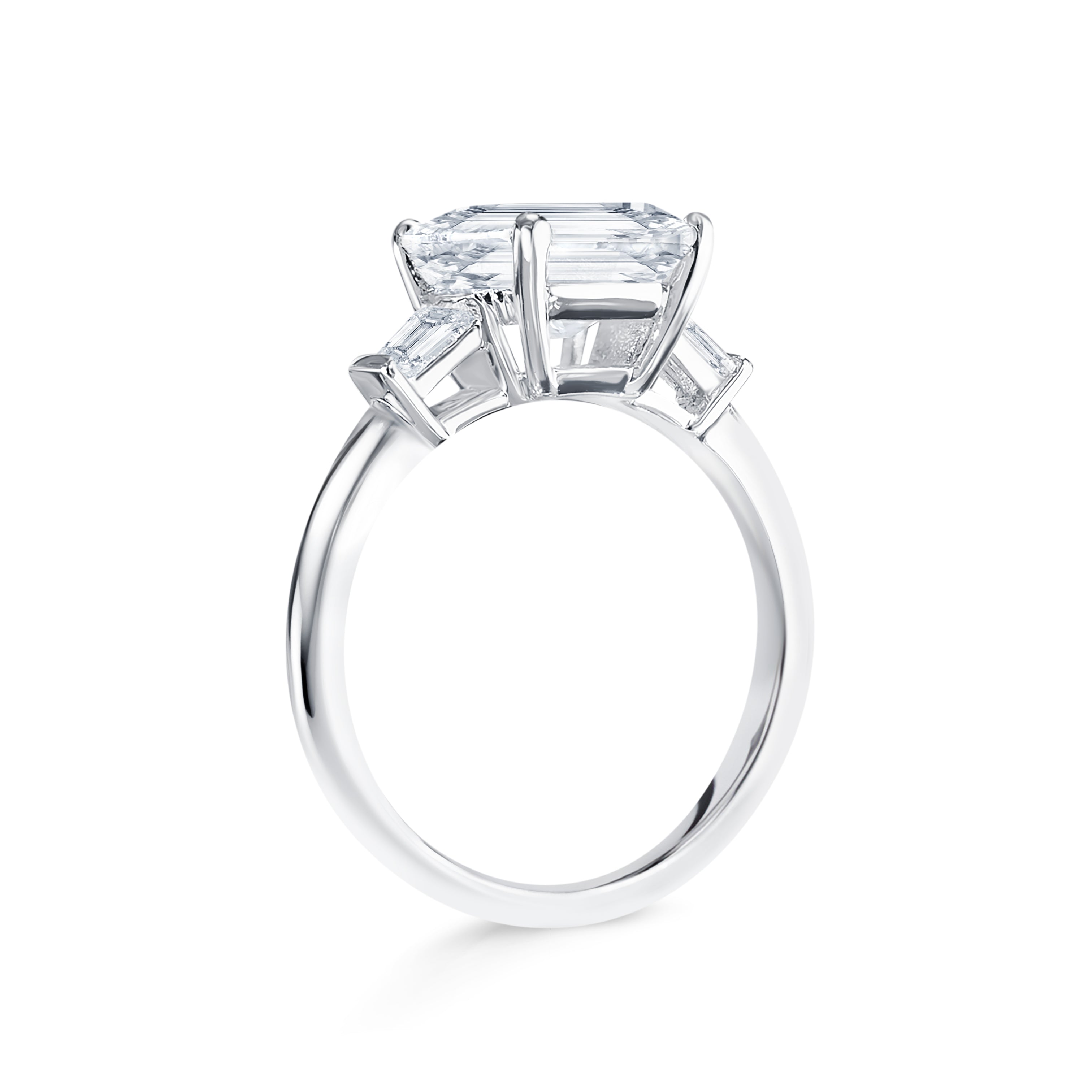 Trista - Micheli Jewellery, trilogy ring side profile. emerald cut trilogy ring on the side. baguette diamond ring on side. white gold trilogy ring side profile. floating setting engagement ring on the side.