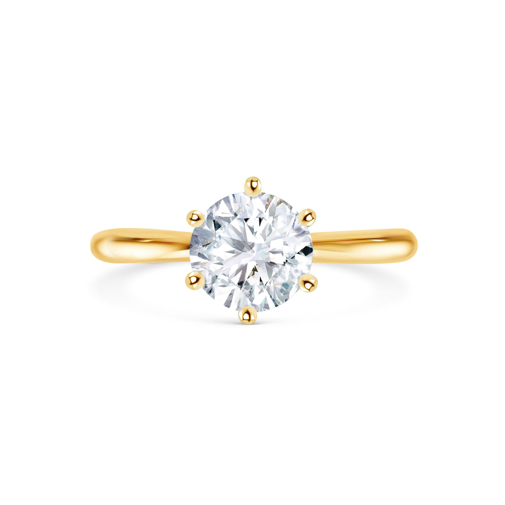 Beautiful round brilliant diamond engagement ring with yellow gold in six claw setting. Melbourne, Australia. Round brilliant cut diamond engagement ring with 6 claw setting in yellow gold. Gold band on engagement ring. Solitaire engagement ring. 