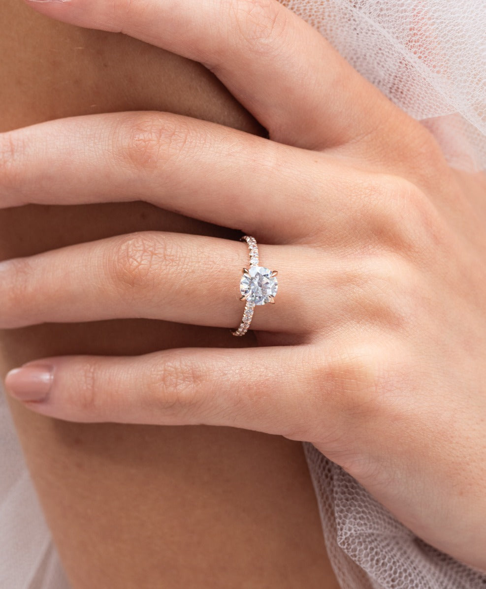 Rose - Micheli Jewellery, Diamond Engagement Ring, Rose Gold Engagement Ring with Round Brilliant Cut Centre Stone with 4 flaws and a Diamond Pave Band on hand. Diamond Engagement Ring modelled on hand. Rose gold Engagement Ring. Rose gold engagement ring on hand.