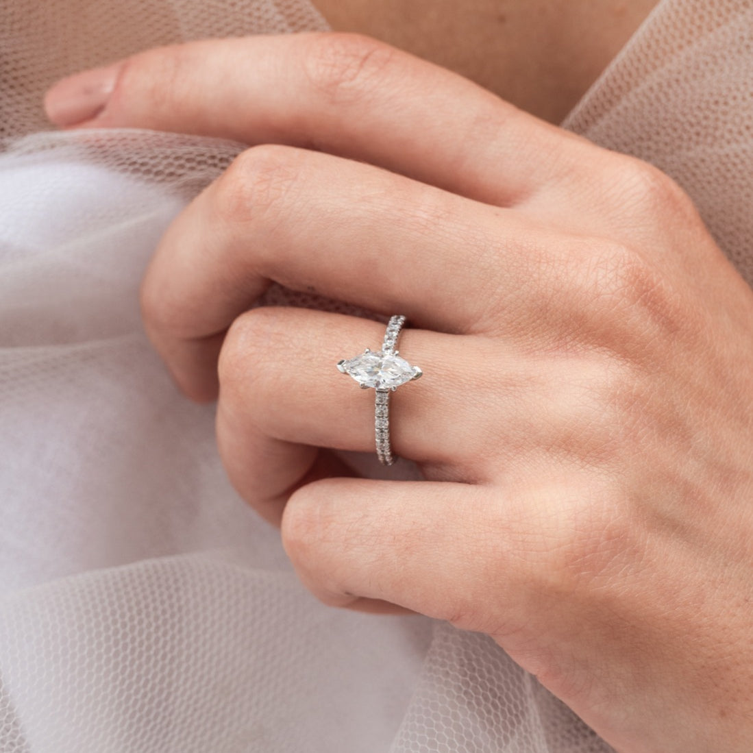 Moniqua - Micheli Jewellery. Marquise diamond engagement ring modelled on hand. Marquise 6 prong engagement ring with diamond band in white gold modelled on hand. Marquise diamond on hand. Engagement ring modelled on hand.