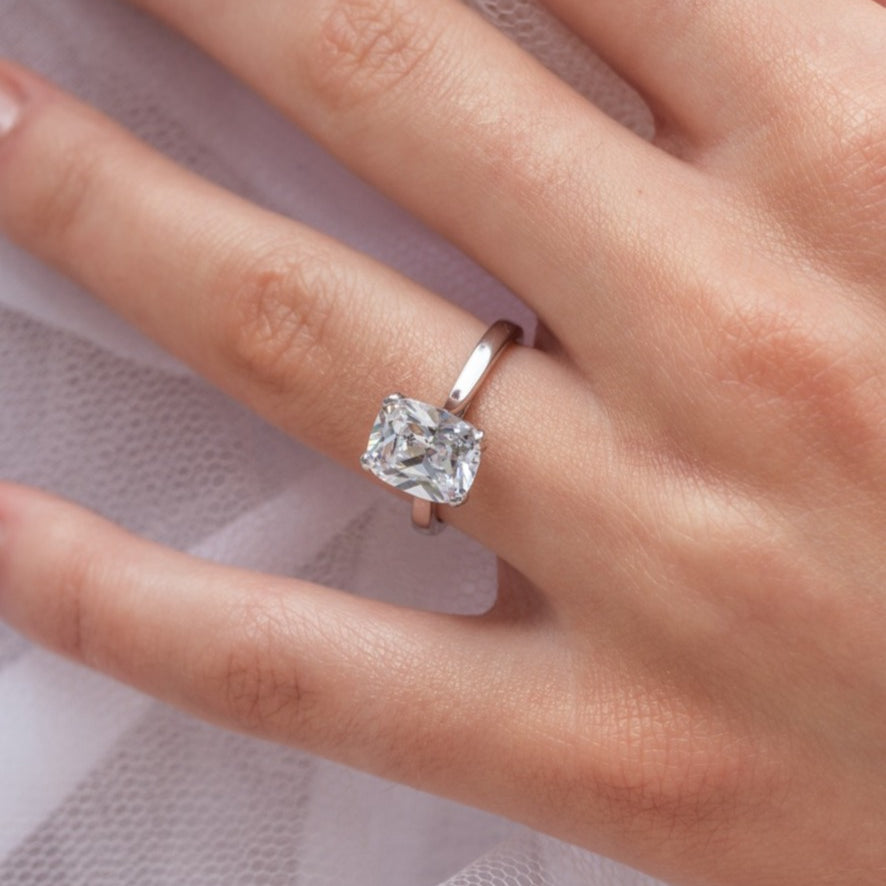 Athra - Micheli Jewellery, elongated cushion cut diamond solitaire engagement ring modelled on the hand. elongated cushion cut on hand. elongated cushion cut solitaire on hand. solitaire on hand.