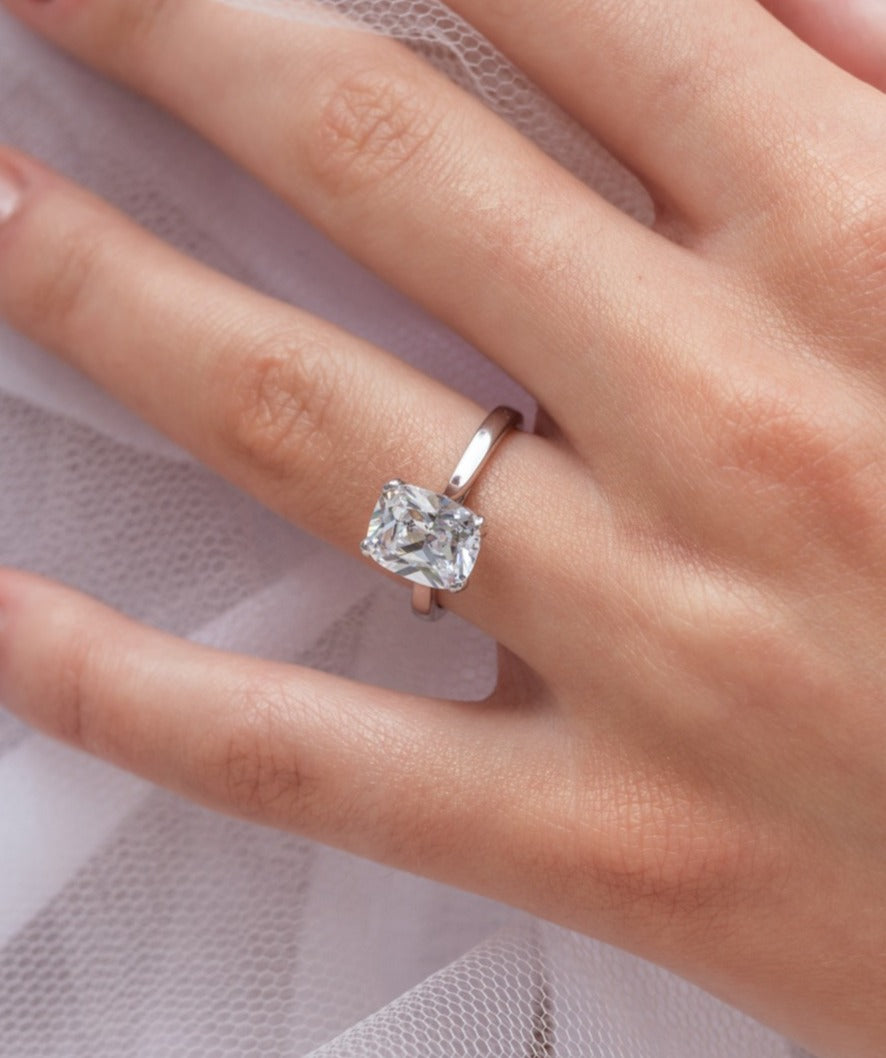 Athra - Micheli Jewellery, elongated cushion cut diamond solitaire engagement ring modelled on the hand. elongated cushion cut on hand. elongated cushion cut solitaire on hand. solitaire on hand.
