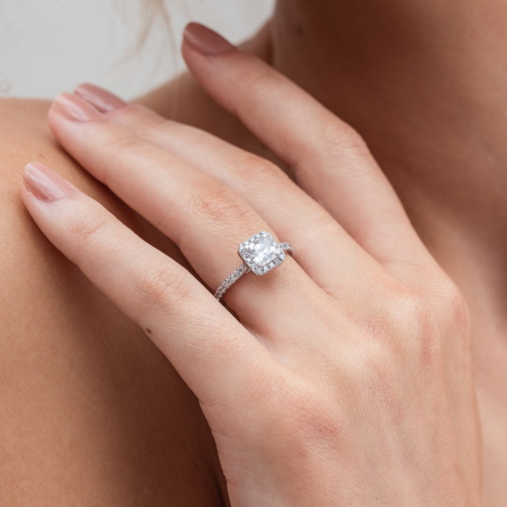 Kayla - Micheli Jewellery, white gold diamond engagement ring with diamond halo and diamond band with large princess cut diamond as centre stone. platinum engagement ring. white gold engagement ring. engagement ring modelled on hand. modelled engagement ring.