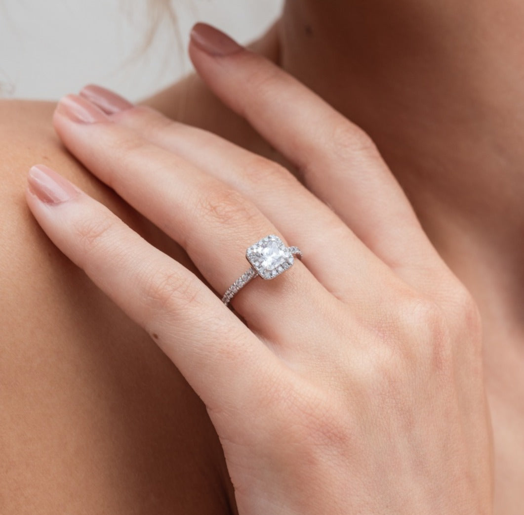 Kayla - Micheli Jewellery, white gold diamond engagement ring with diamond halo and diamond band with large princess cut diamond as centre stone. platinum engagement ring. white gold engagement ring. engagement ring modelled on hand. modelled engagement ring.