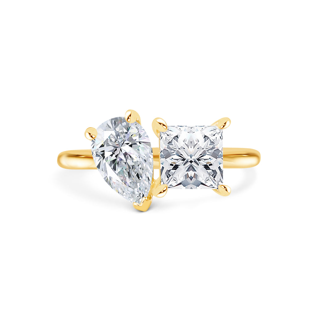 Toi et Moi ring with a Pear shaped & princess shaped diamonds in yellow gold band Micheli Jewellery