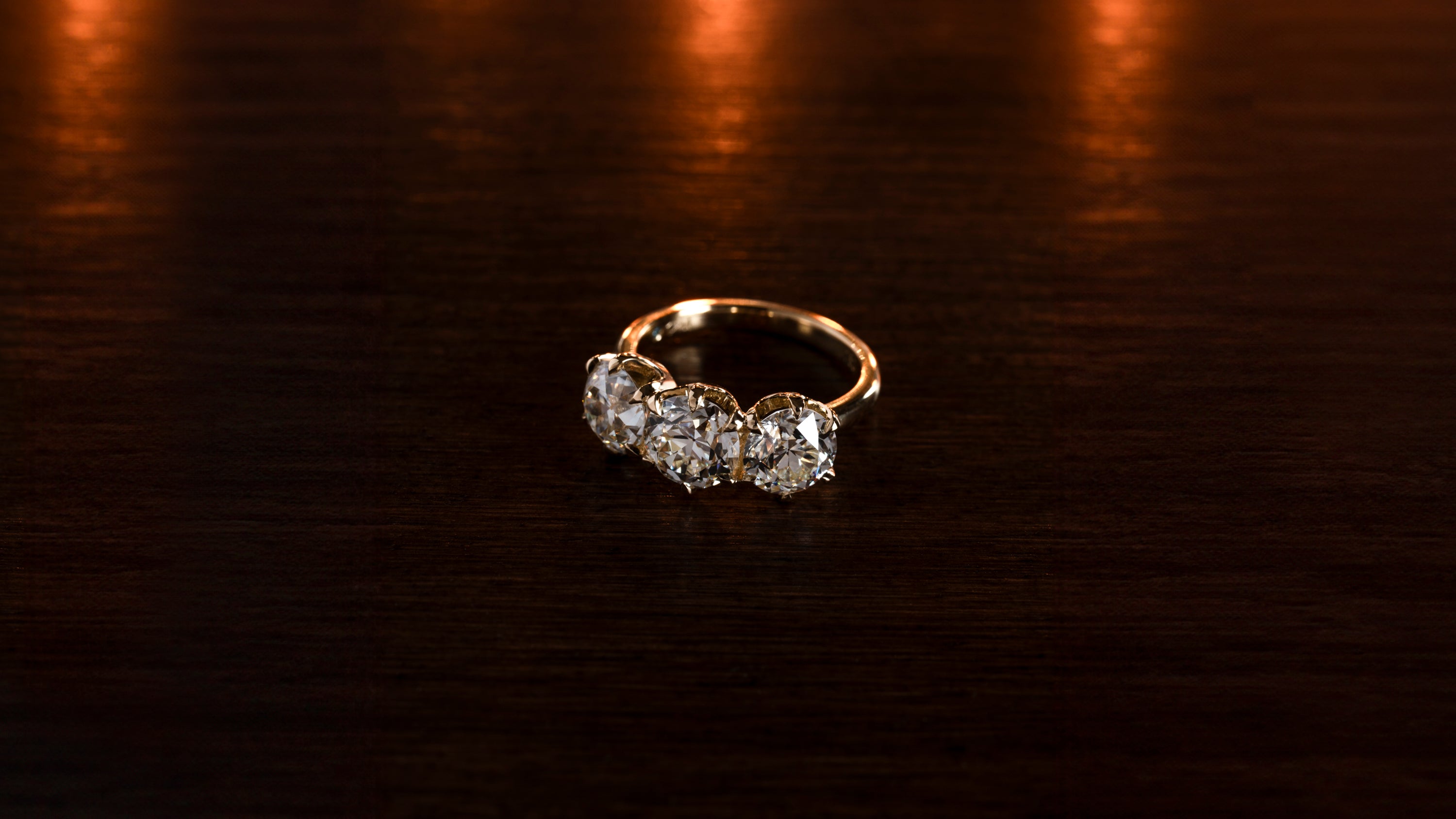 Diamond ring on a dark wooden surface
