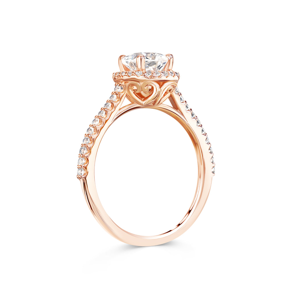 Rebecca - Micheli Jewellery, side ring profile of diamond engagement. engagement ring basket with love hearts. diamond halo and half diamond band engagement ring in rose gold. engagement ring with swept up shoulders. 4 claw setting on engagement ring. 
