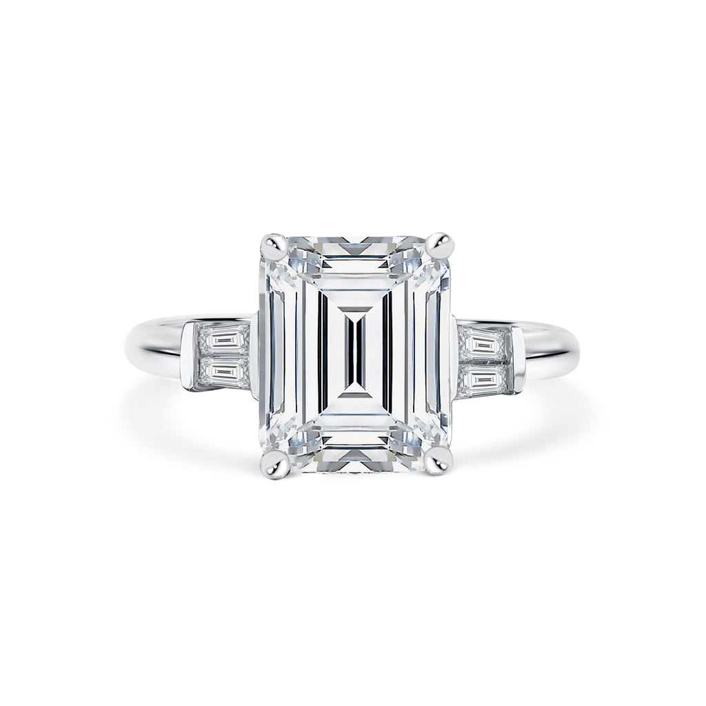 Trista - Micheli Jewellery, emerald cut diamond trilogy ring. trilogy ring profile. baguette diamond side stone ring. white gold trilogy ring. emerald cut trilogy ring. art deco styled ring. white gold 4 claw trilogy ring with emerald radiant cut diamond and baguette diamond side stones. 