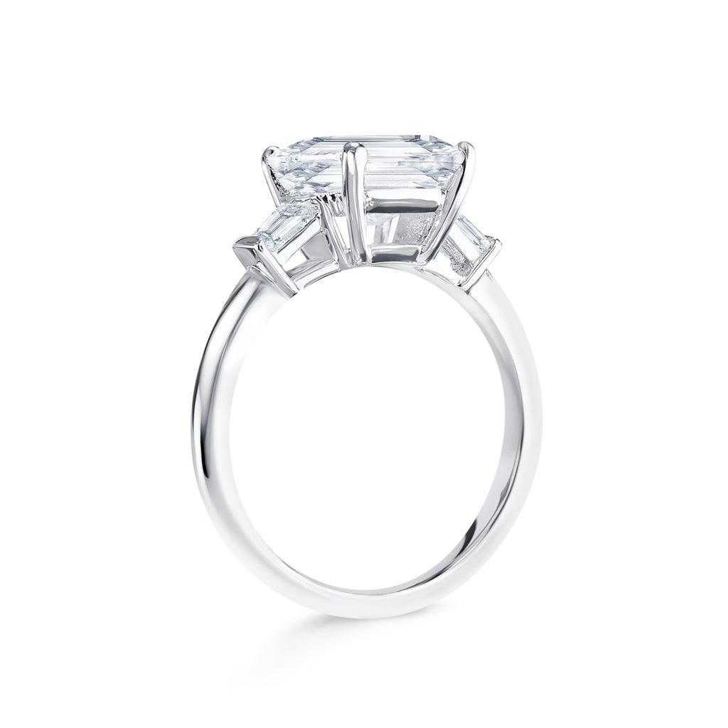 Trista - Micheli Jewellery, trilogy ring side profile. emerald cut trilogy ring on the side. baguette diamond ring on side. white gold trilogy ring side profile. floating setting engagement ring on the side. 